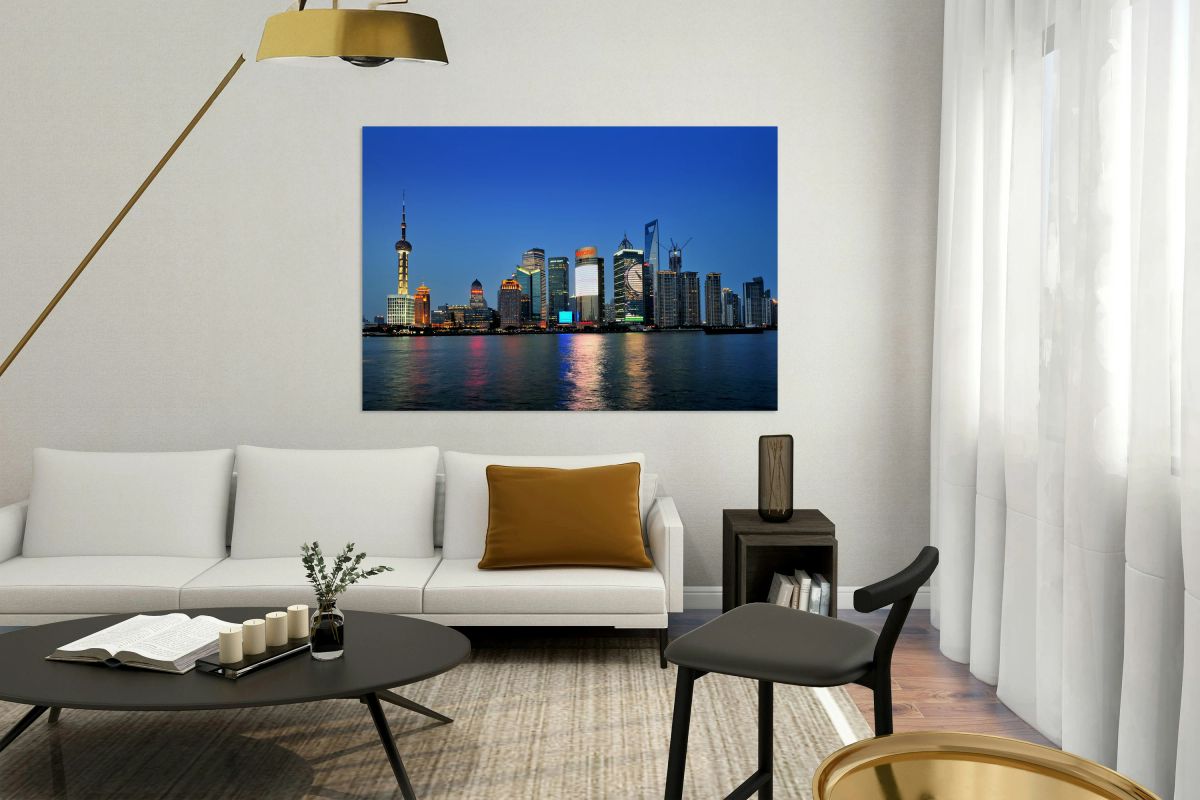 Shanghai skyline lights up at night over the river