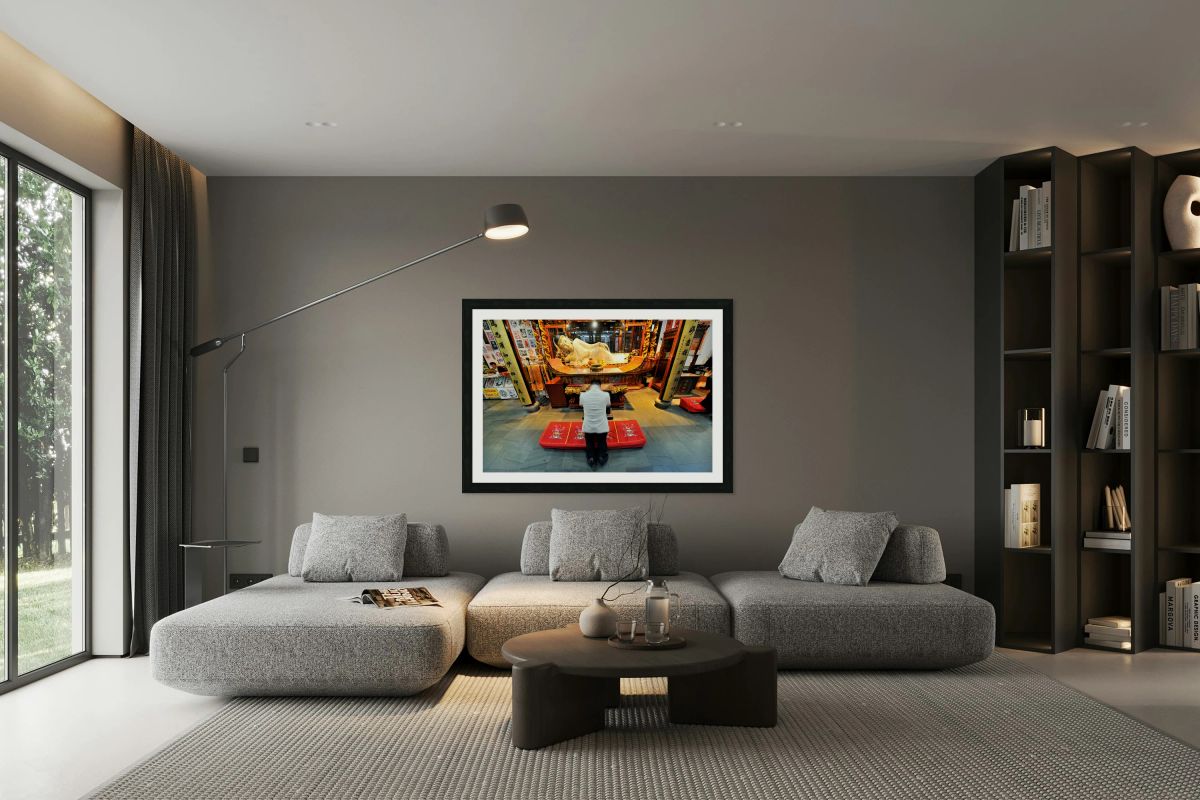 Worshipper kneels before Buddha statue in Shanghai temple