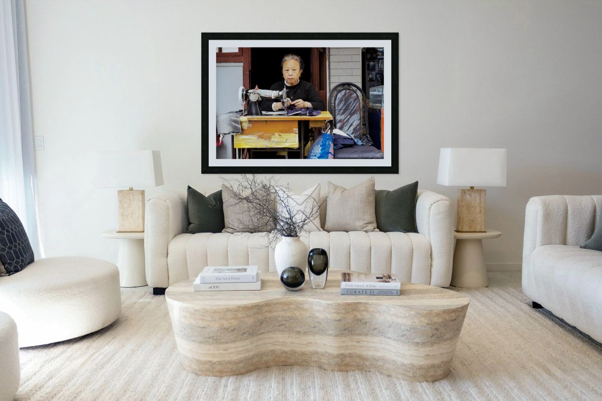 Elderly woman sews at machine in Shanghai China