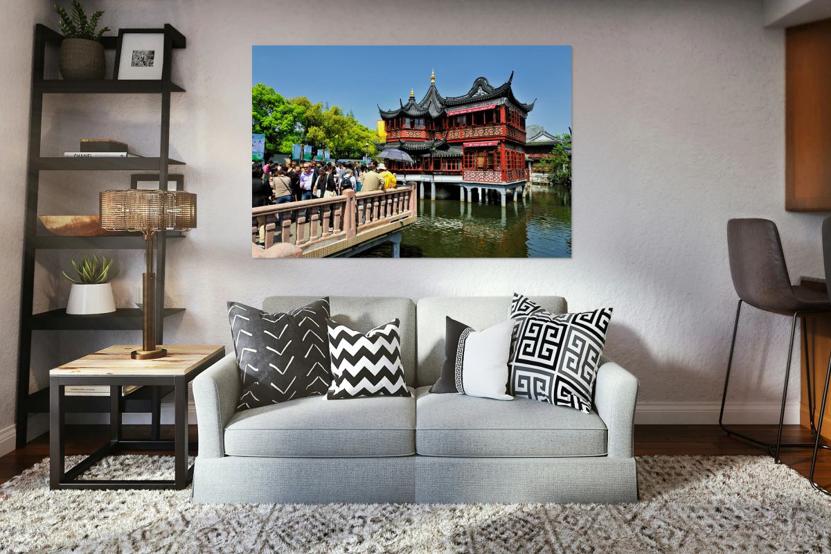 Crowd visits traditional Chinese tea house beside water in Shang