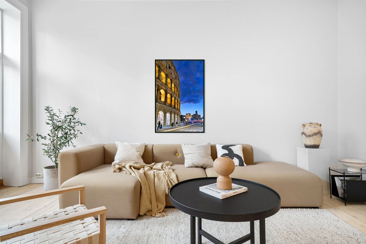 Colosseum at dusk with people walking nearby in Rome