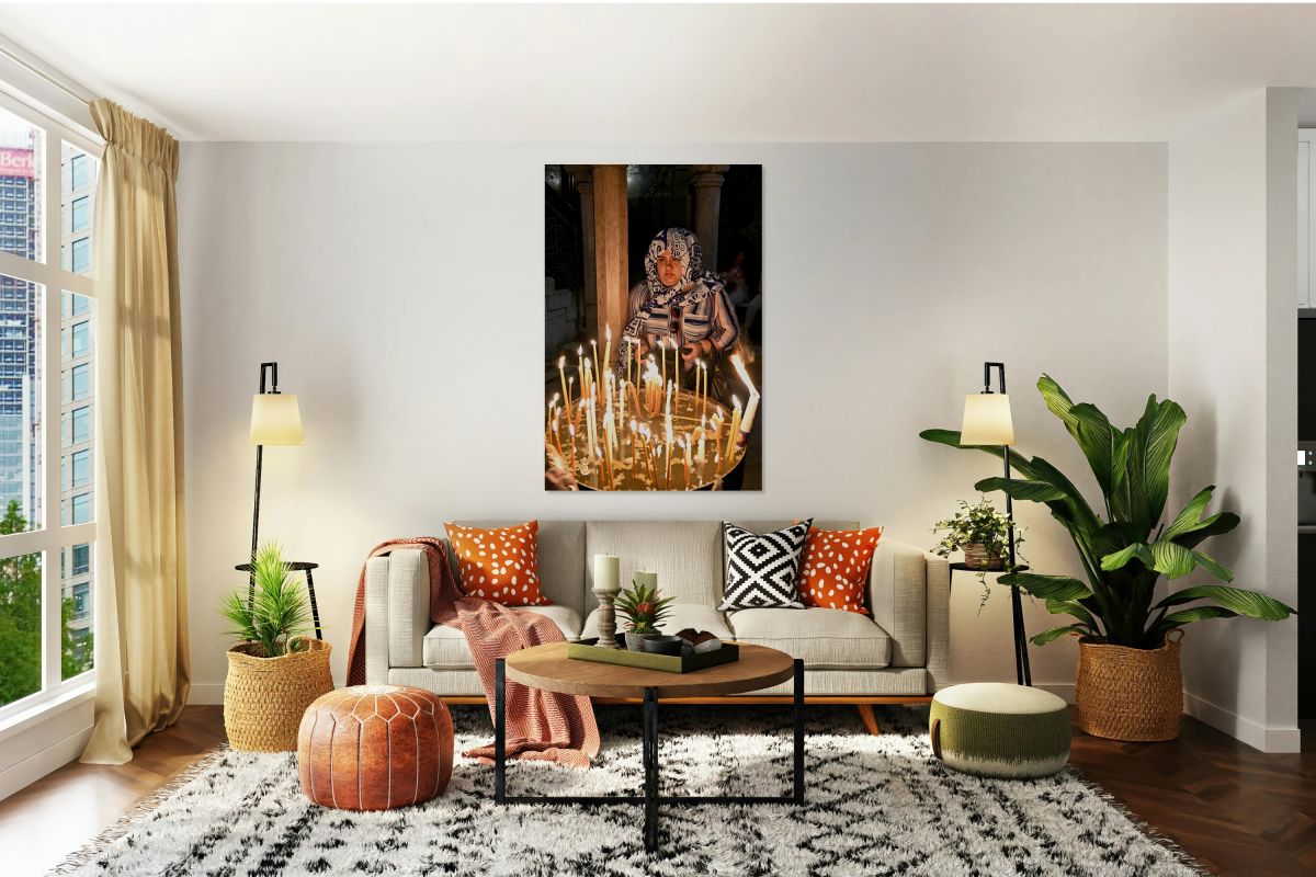 Worshipper lights candles at Holy Sepulchre church in Jerusalem