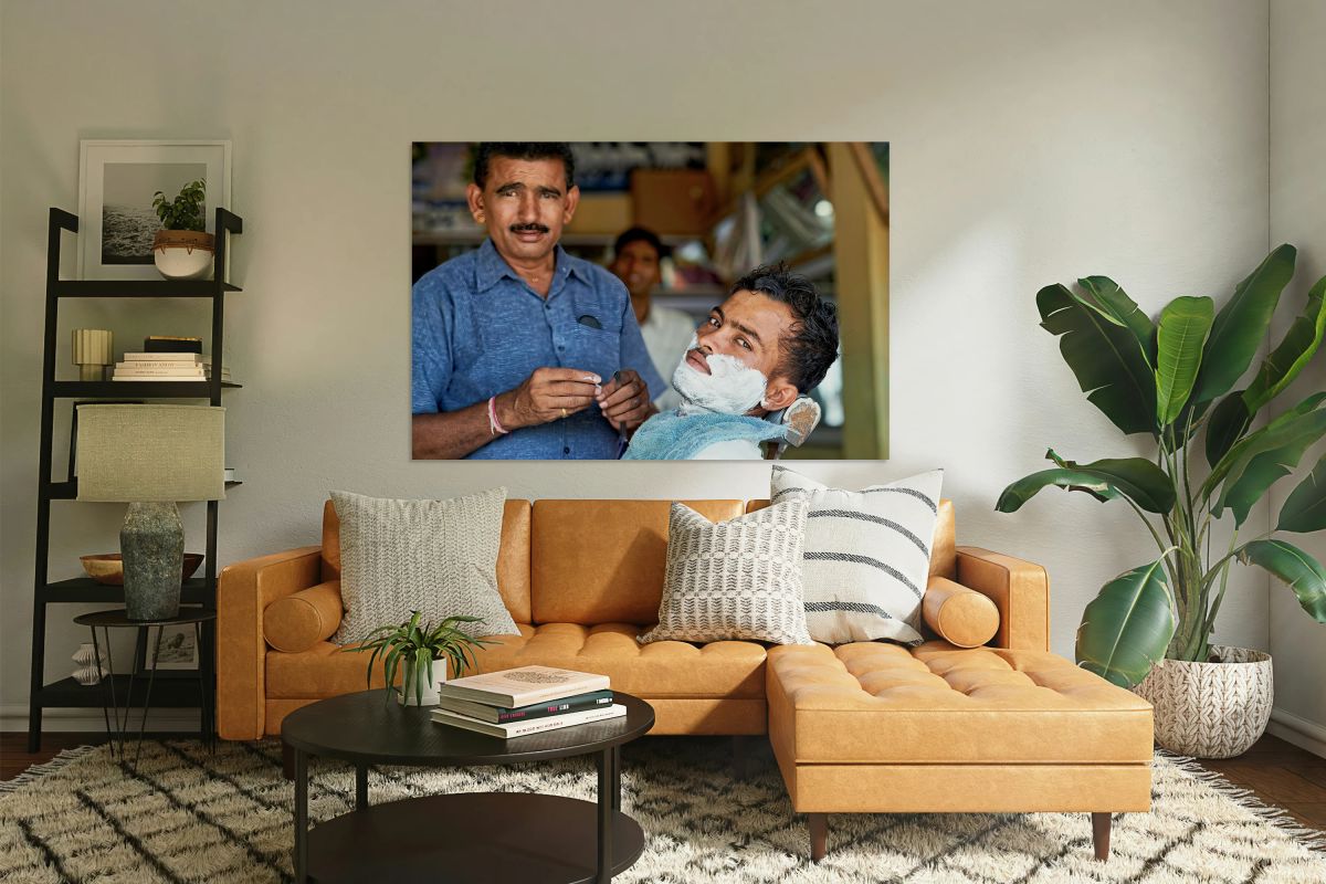 Barber at work in Khimsar Rajasthan India during a busy day