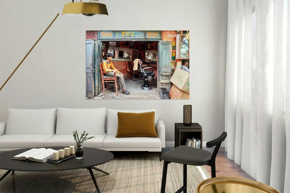 Barber shop scene in Bikaner Rajasthan showing young customer w