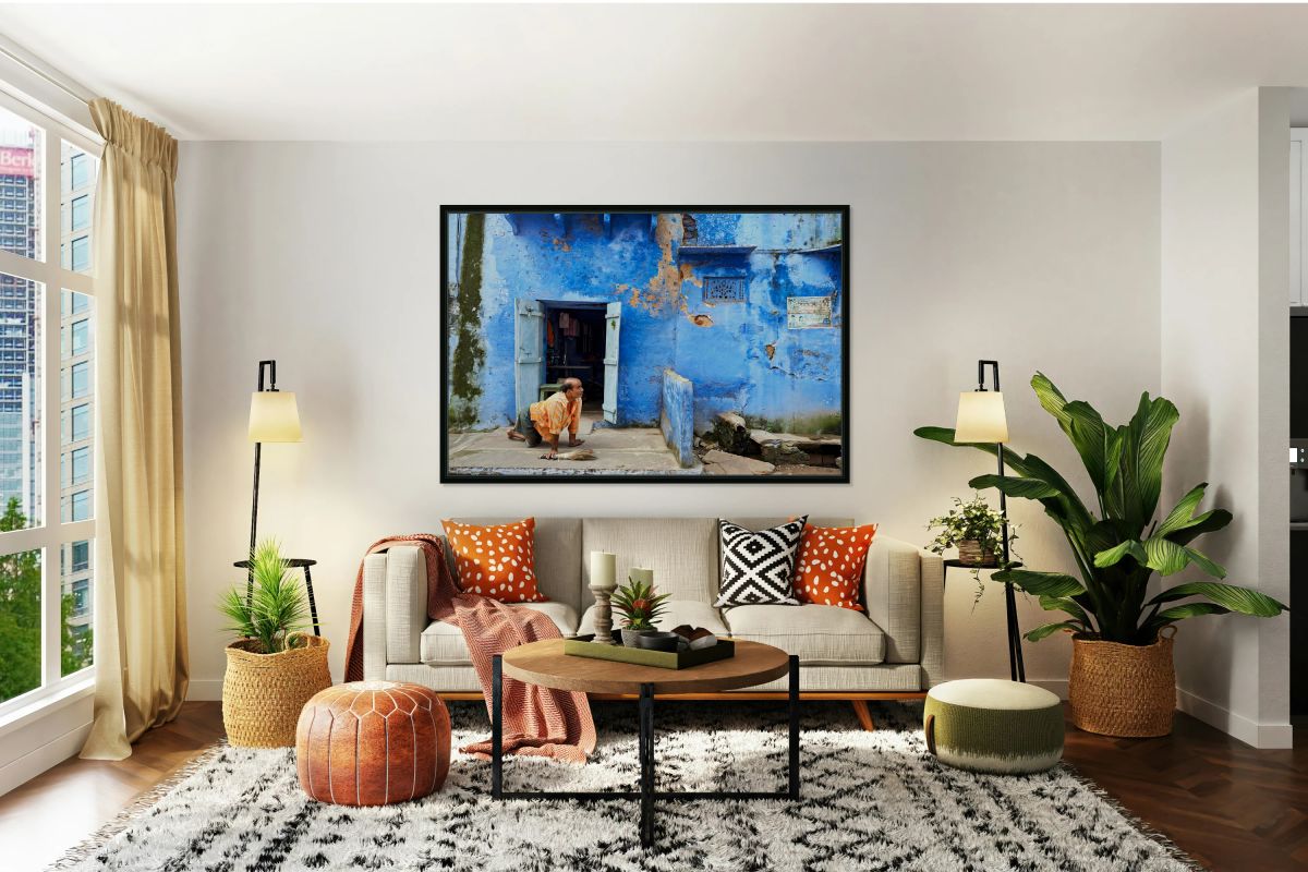 Man sweeps in front of home in Bundi Rajasthan during the day