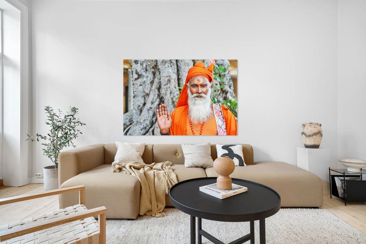 Sadhu in orange robe stands near tree in Jaipur Rajasthan