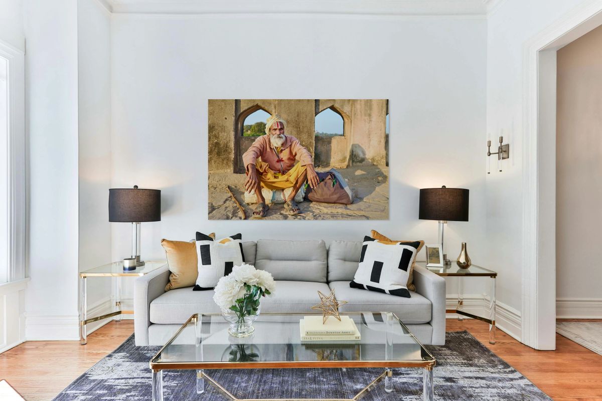 Holy man sitting outside historic building in Orchha India