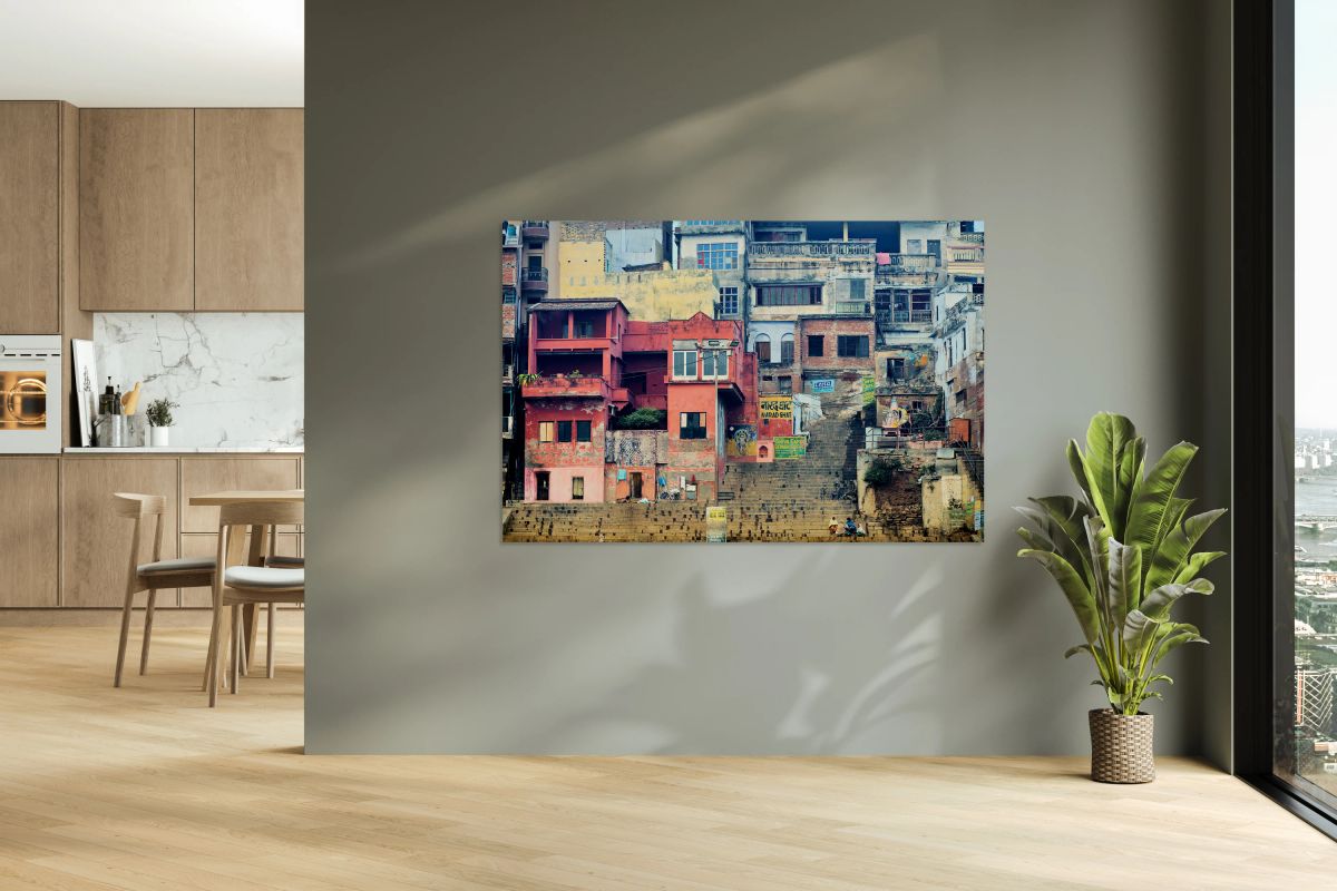 Visitors walk along the ghat by the Ganges river in Varanasi In