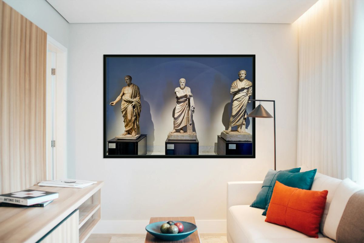 Statues of ancient philosophers displayed in museum setting
