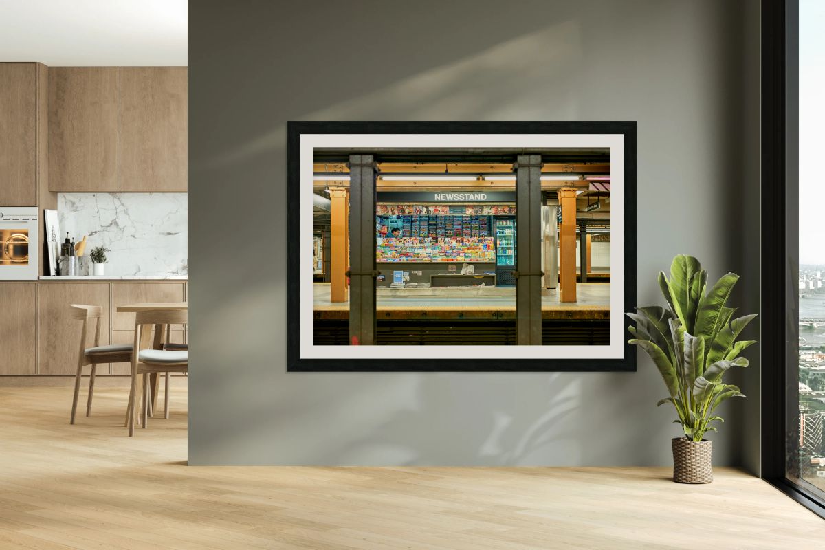 Newsagent yawning at newsstand in Manhattan subway station