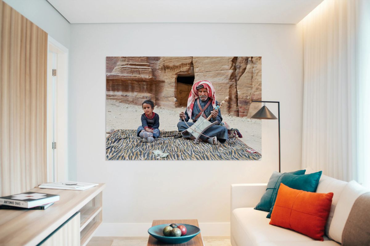 Musician performs in Petra Jordan with a child nearby