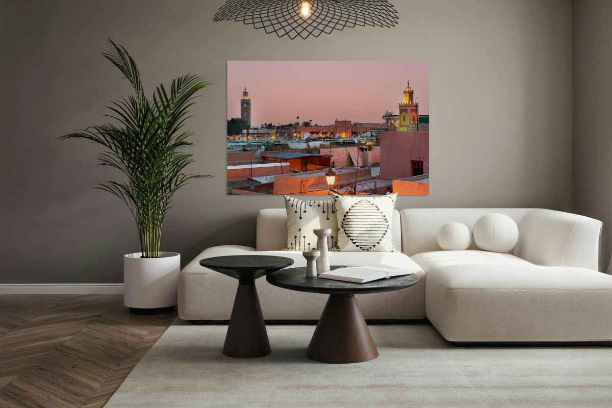 Cityscape of Marrakesh at sunset with buildings and minarets vis