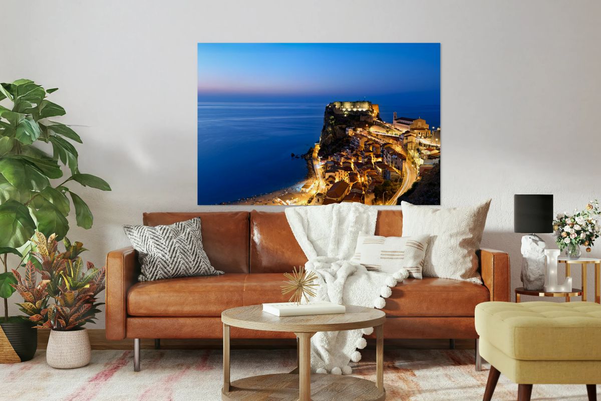 Illuminated Ruffo castle in Scilla Calabria at sunset over the s