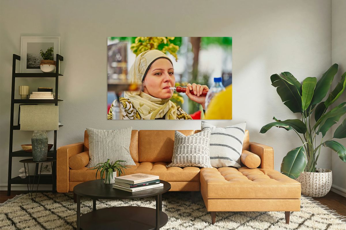 Young woman smokes hookah in Aleppo Syria during a sunny day