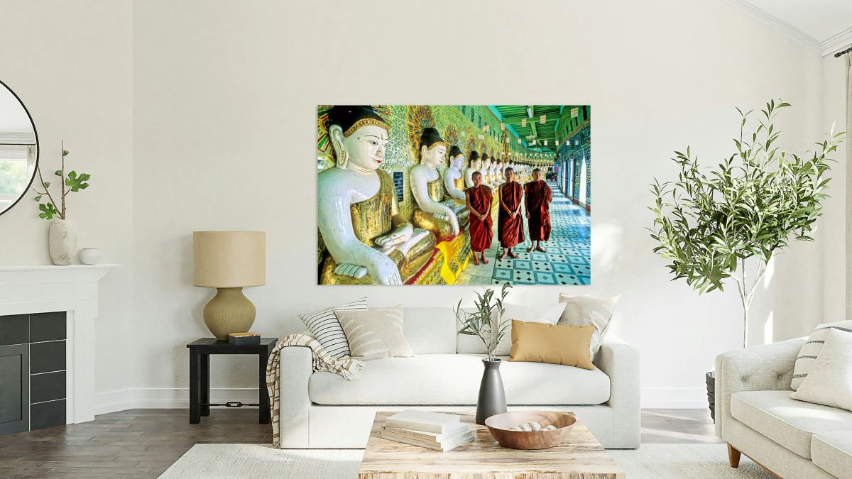 Monks stand by statues in Sagaing Paya in Myanmar