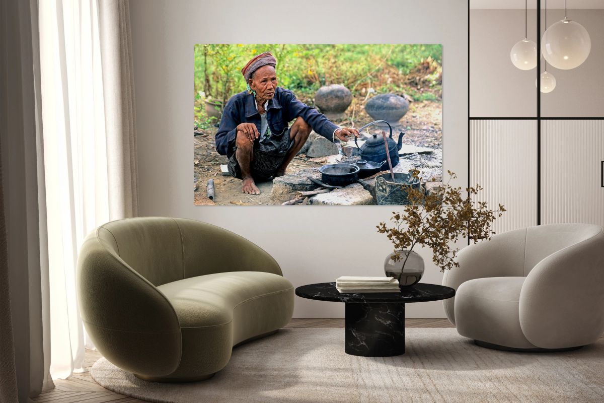 Man prepares tea in Myanmar under a clear sky