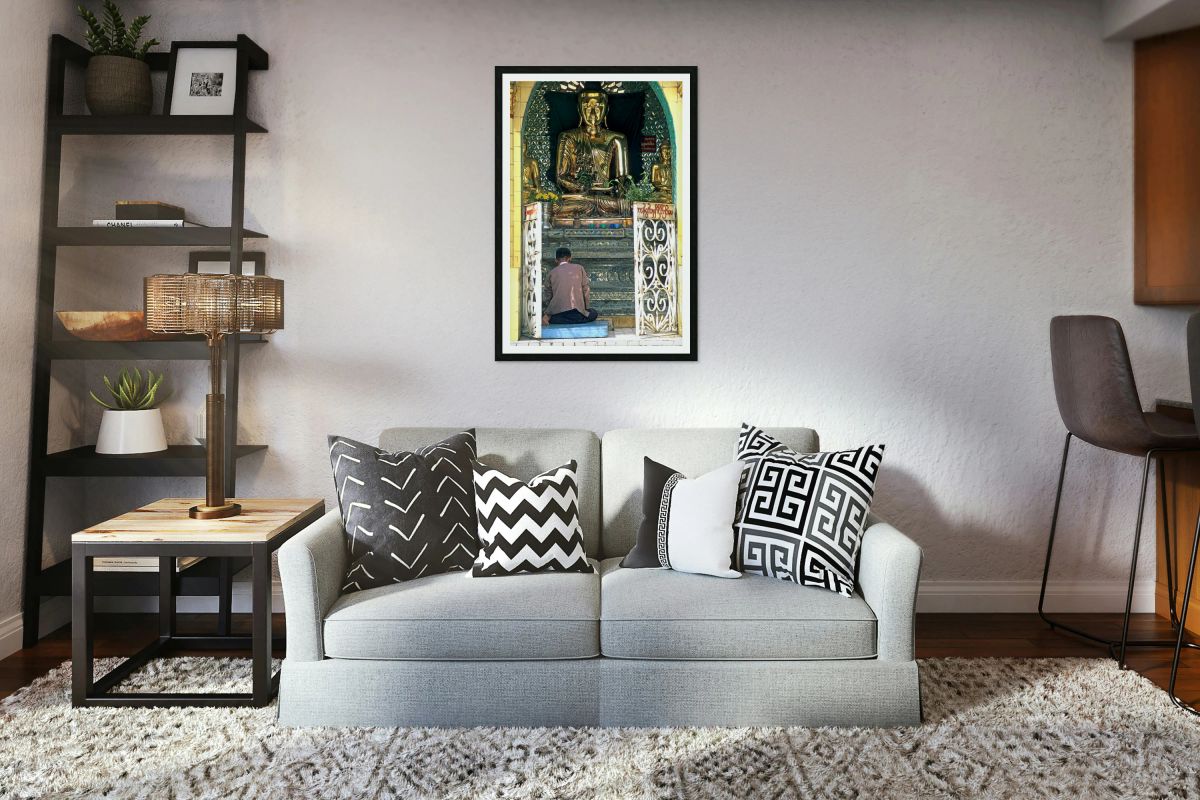 Man prays before a golden Buddha statue in Myanmar chapel