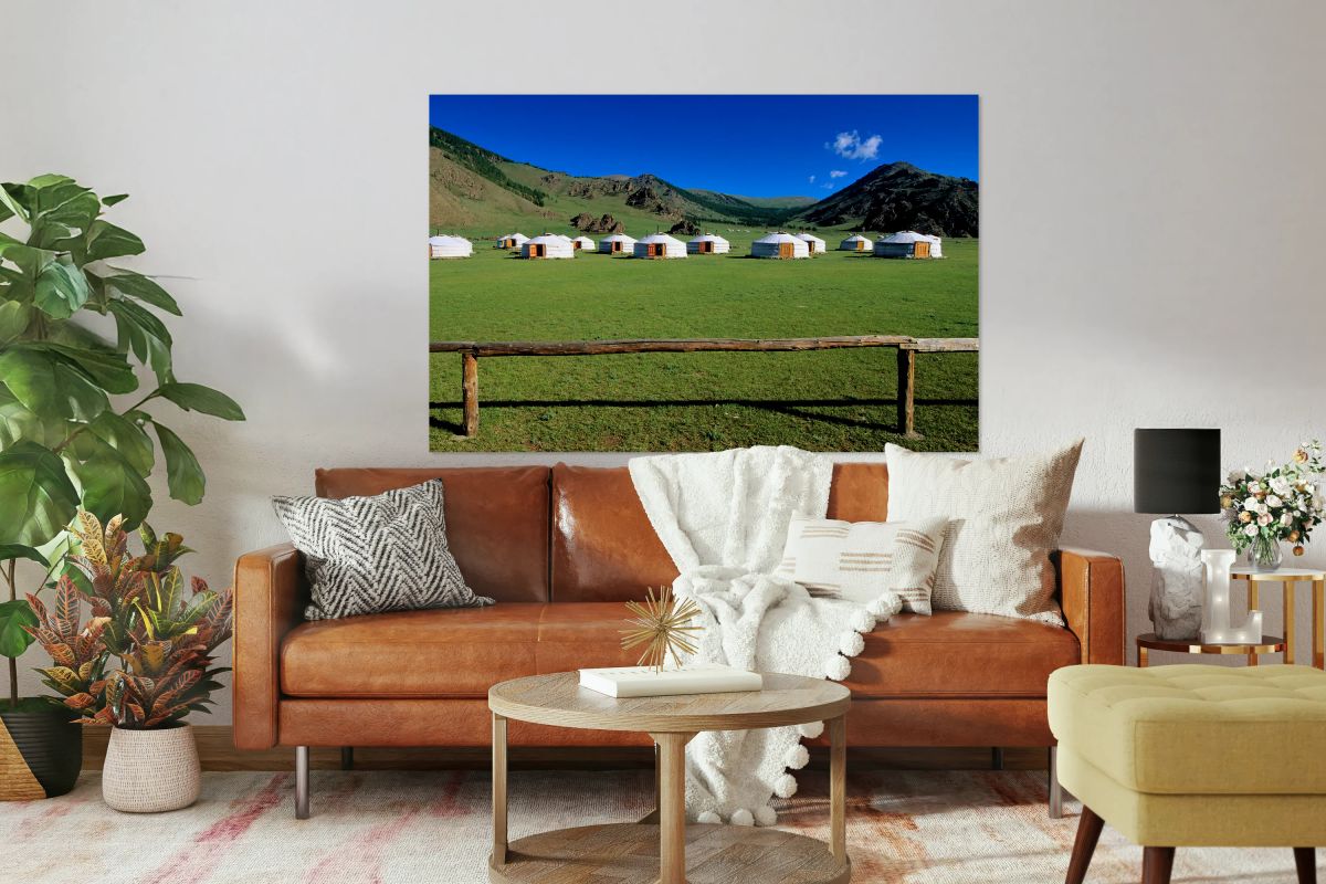 Ger tents in the grassy fields of Mongolia under clear skies