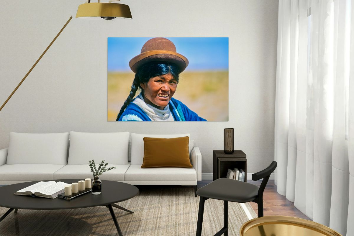 Smiling indigenous woman in hat and braid.