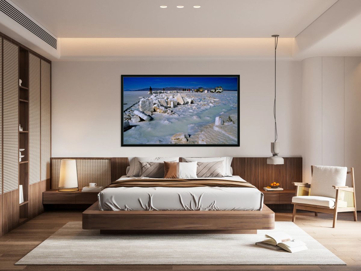 Explorers on a salt flat with salt blocks and water.