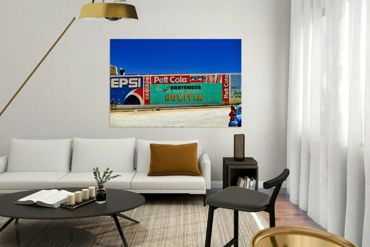 Welcome to Bolivia sign on a wall with old ads.