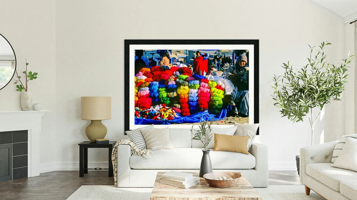 Vibrant market stall with colorful yarn and a smiling child.