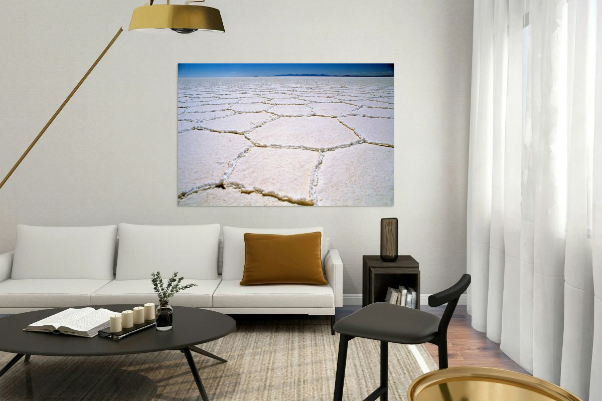 Expansive white salt flat with geometric patterns.