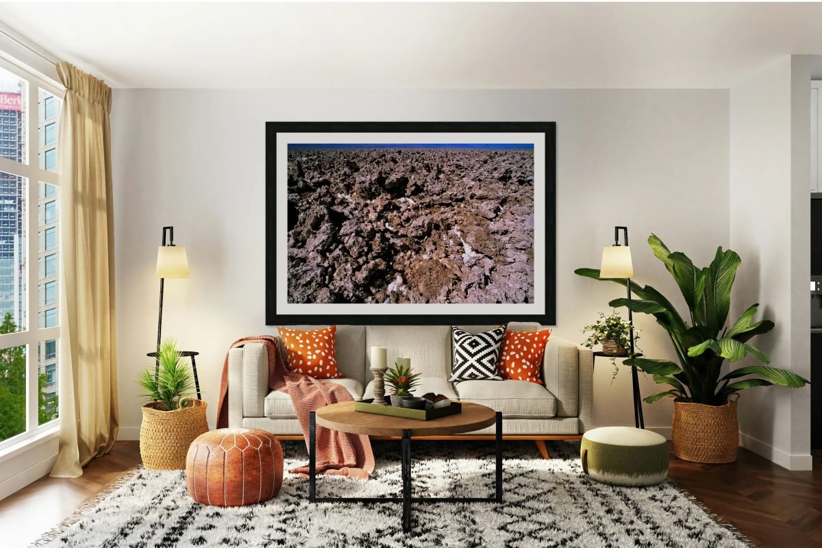 Salt encrusted desert floor under a bright blue sky.