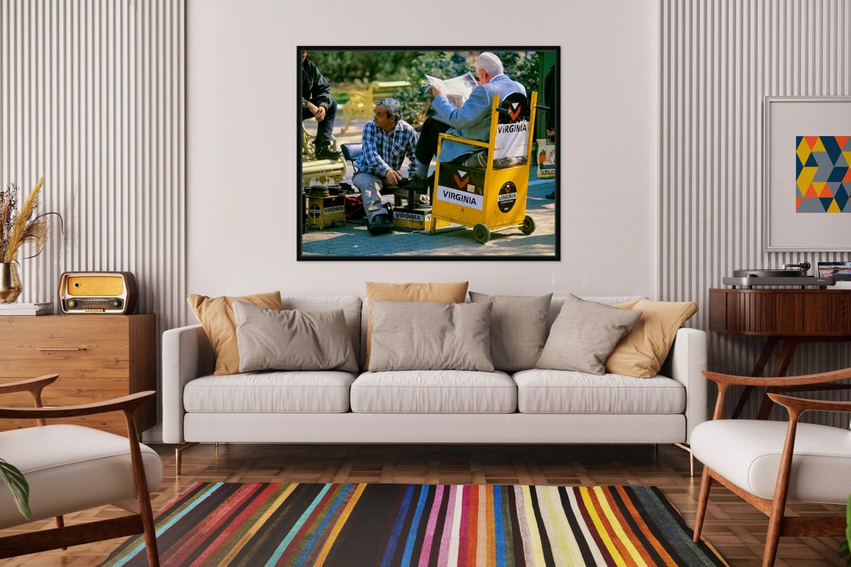 Shoeshine man works while customer reads newspaper.
