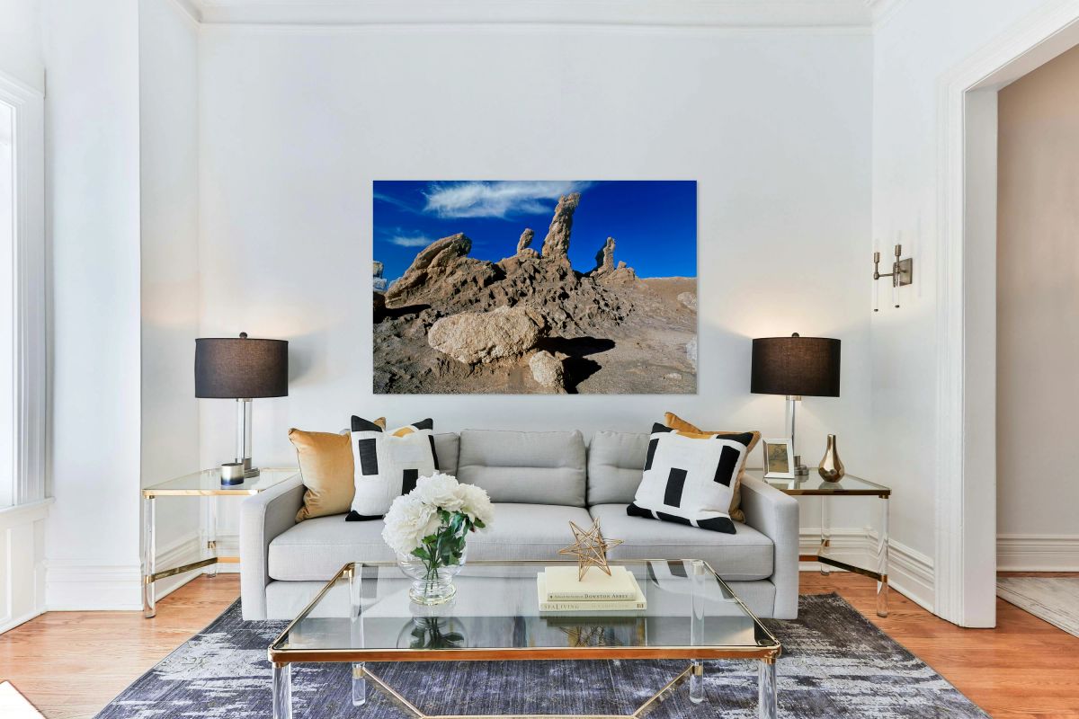 Dramatic desert rock formations under a vibrant blue sky.