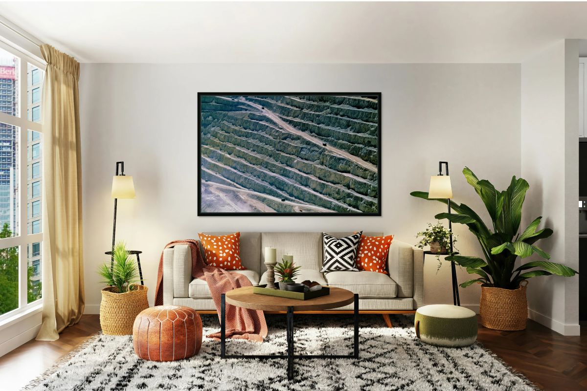 Large open pit mine showing terraced levels and mining trucks.