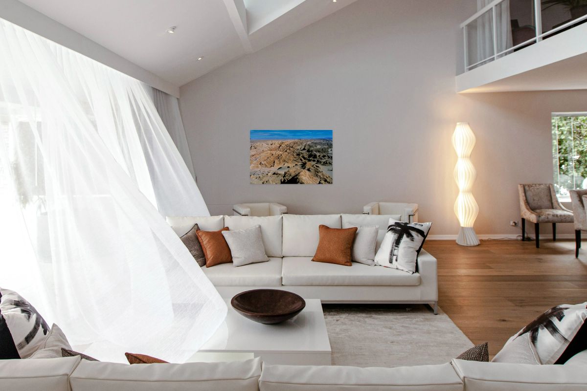 Dramatic desert landscape with eroded formations under a blue sk