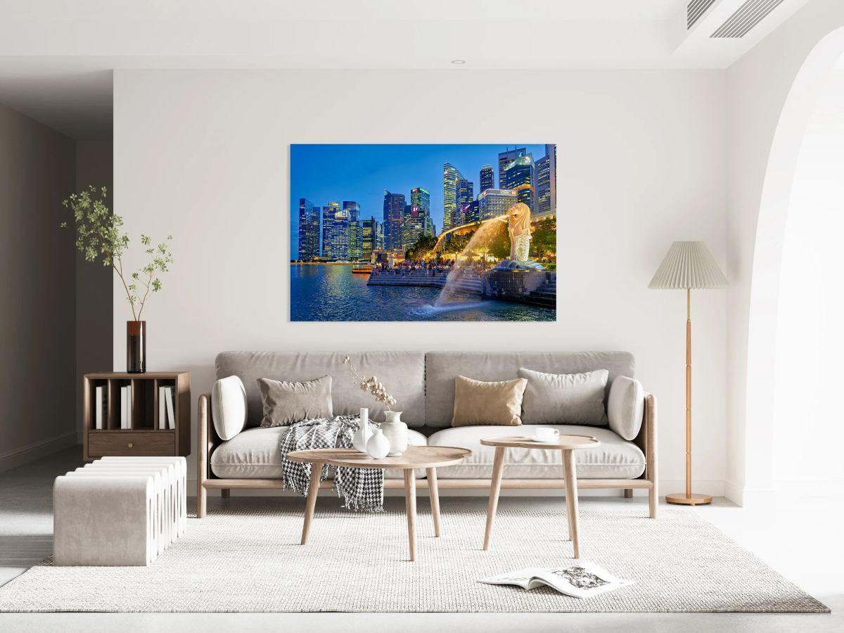 Visitors enjoy the Merlion fountain near Marina Bay Sands at dus