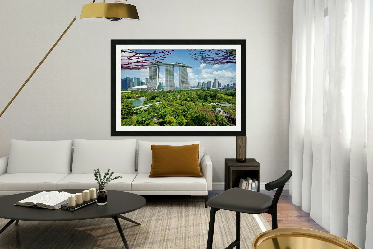 People walk on bridge at Supertree Grove near modern buildings