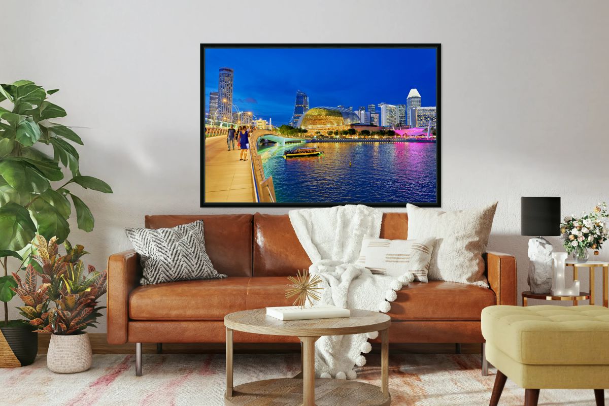 People walk by Marina Bay waterfront as city lights turn on at s