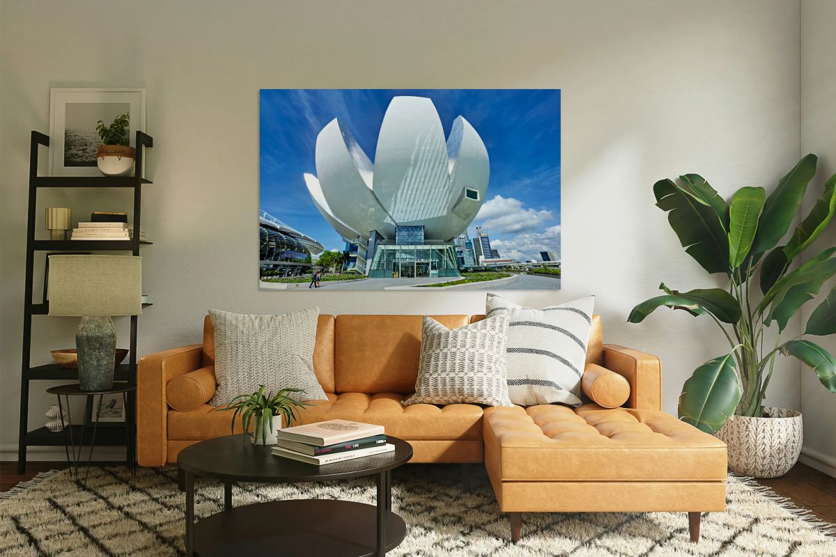 Visitors look at ArtScience Museum with city skyline on a clear 