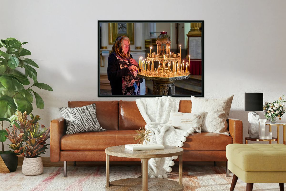 Woman lights candles at Alexander Nevsky Lavra