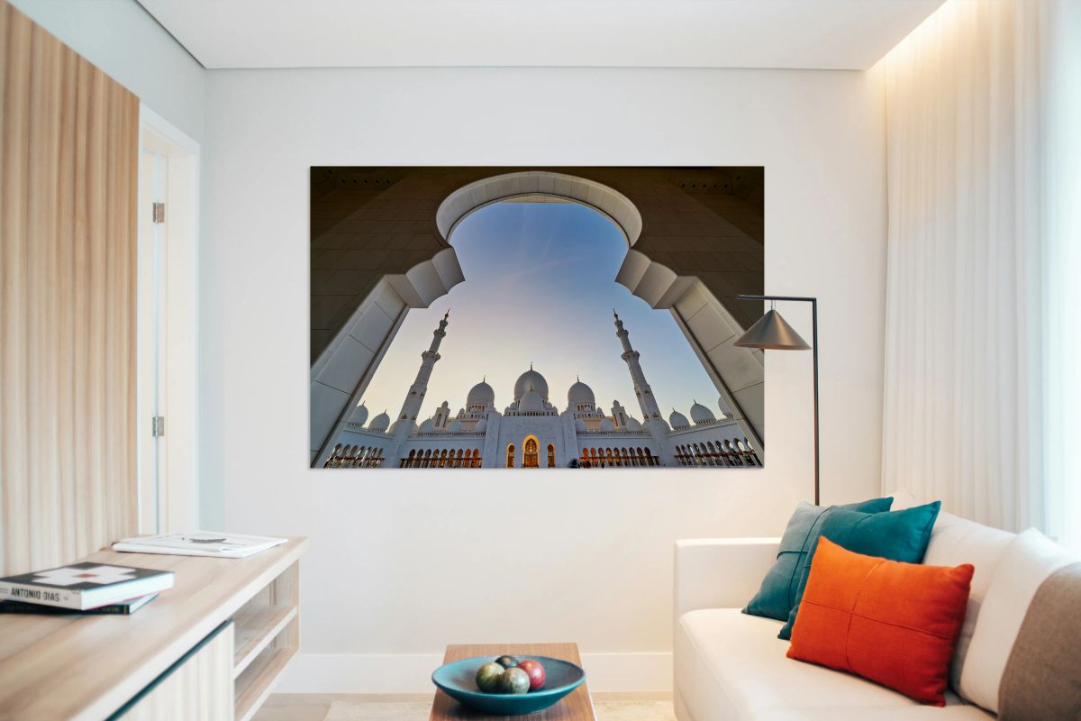 Sheikh Zayed Grand Mosque viewed from an arch at sunset