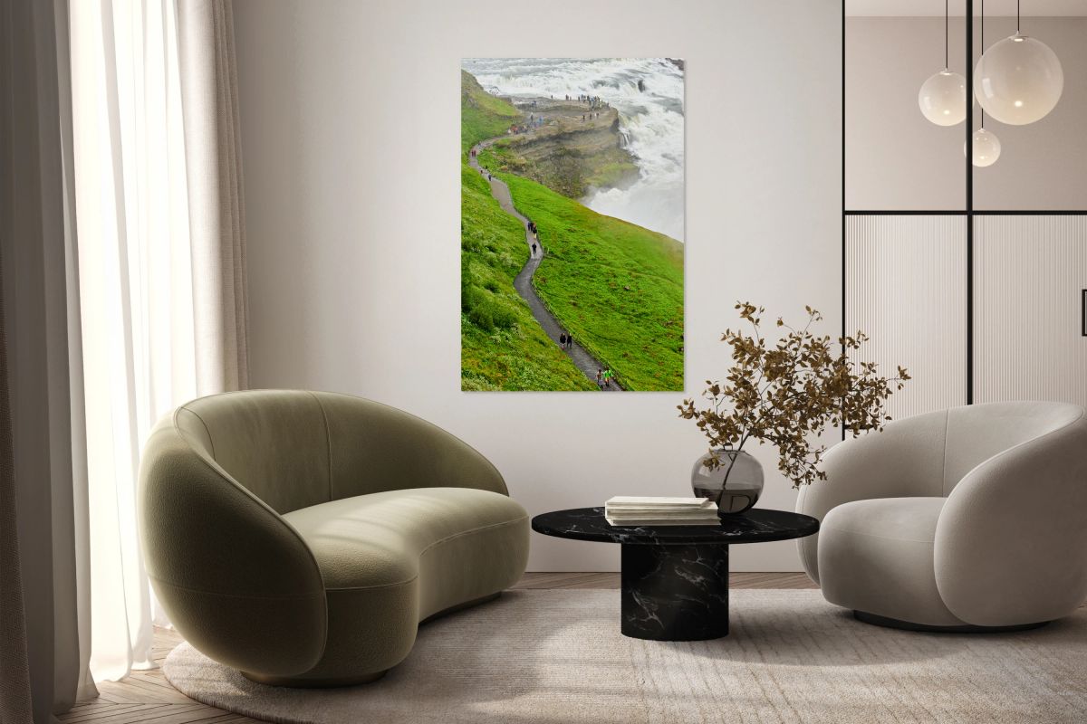 Visitors explore Gullfoss waterfall in Iceland on a cloudy day