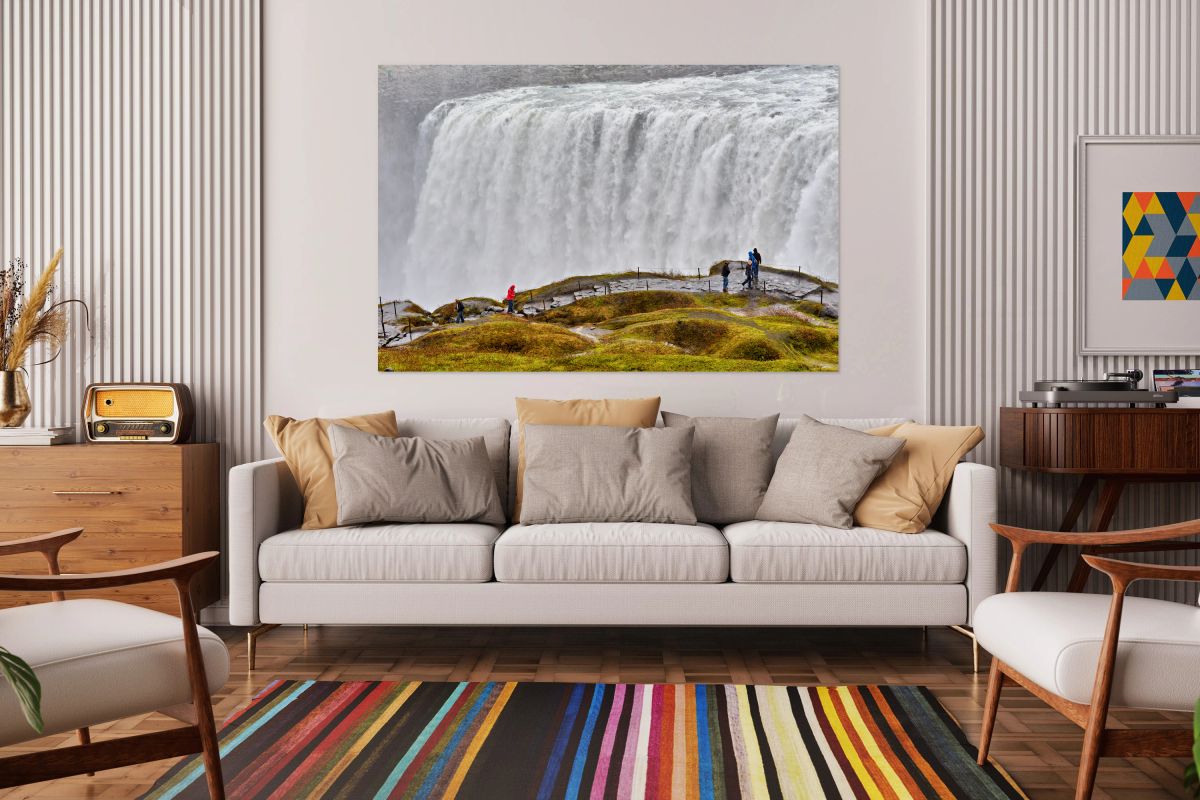 Visitors by Dettifoss waterfall in cloudy Iceland