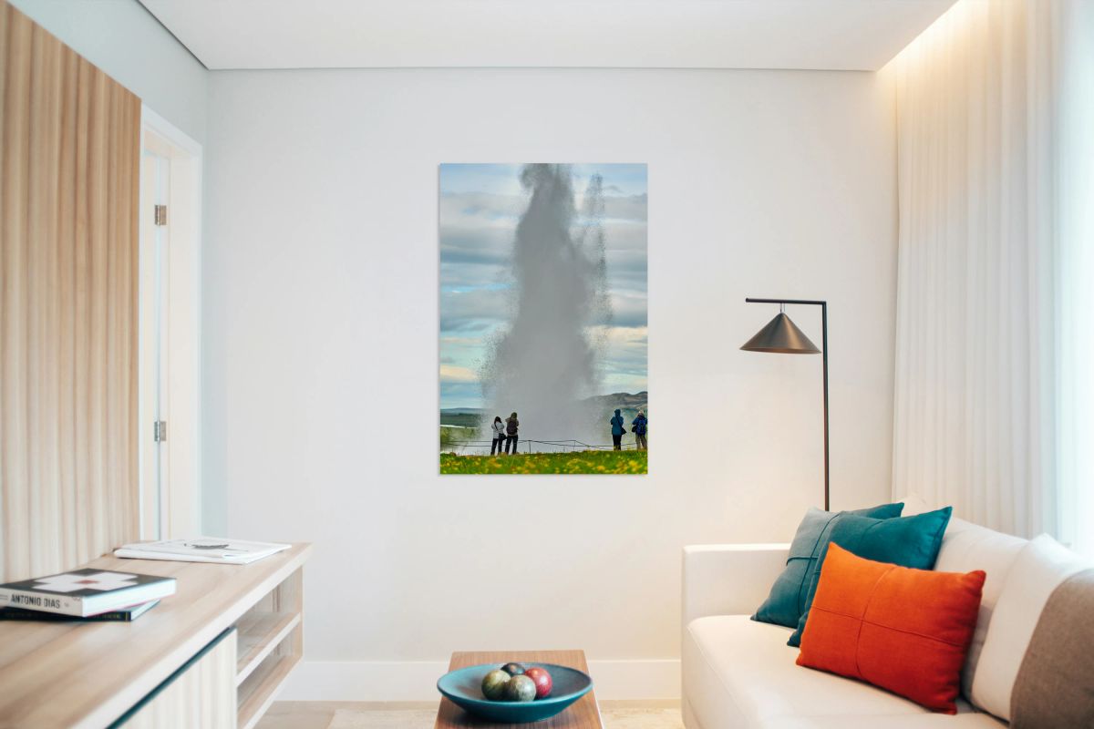 Strokkur geyser erupts in Iceland with visitors nearby