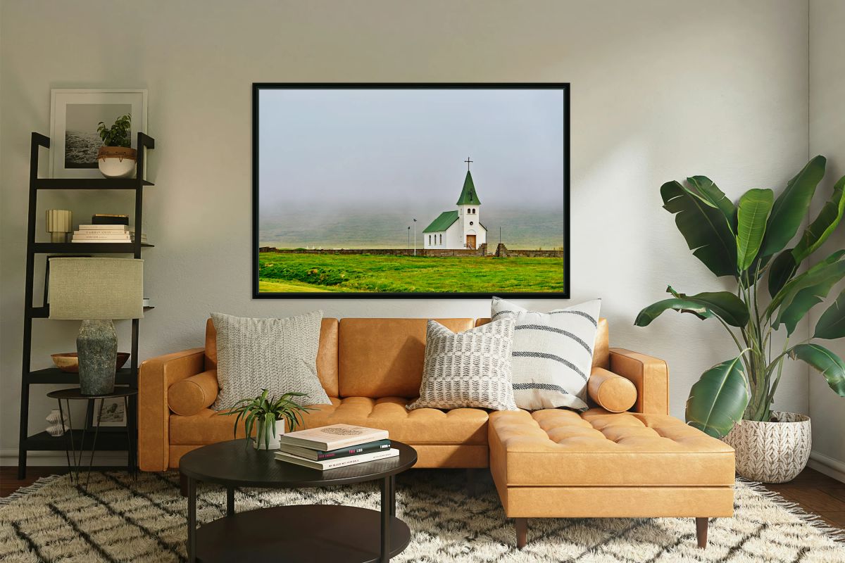 Tjarnarkirkja church stands alone in foggy landscape in Iceland
