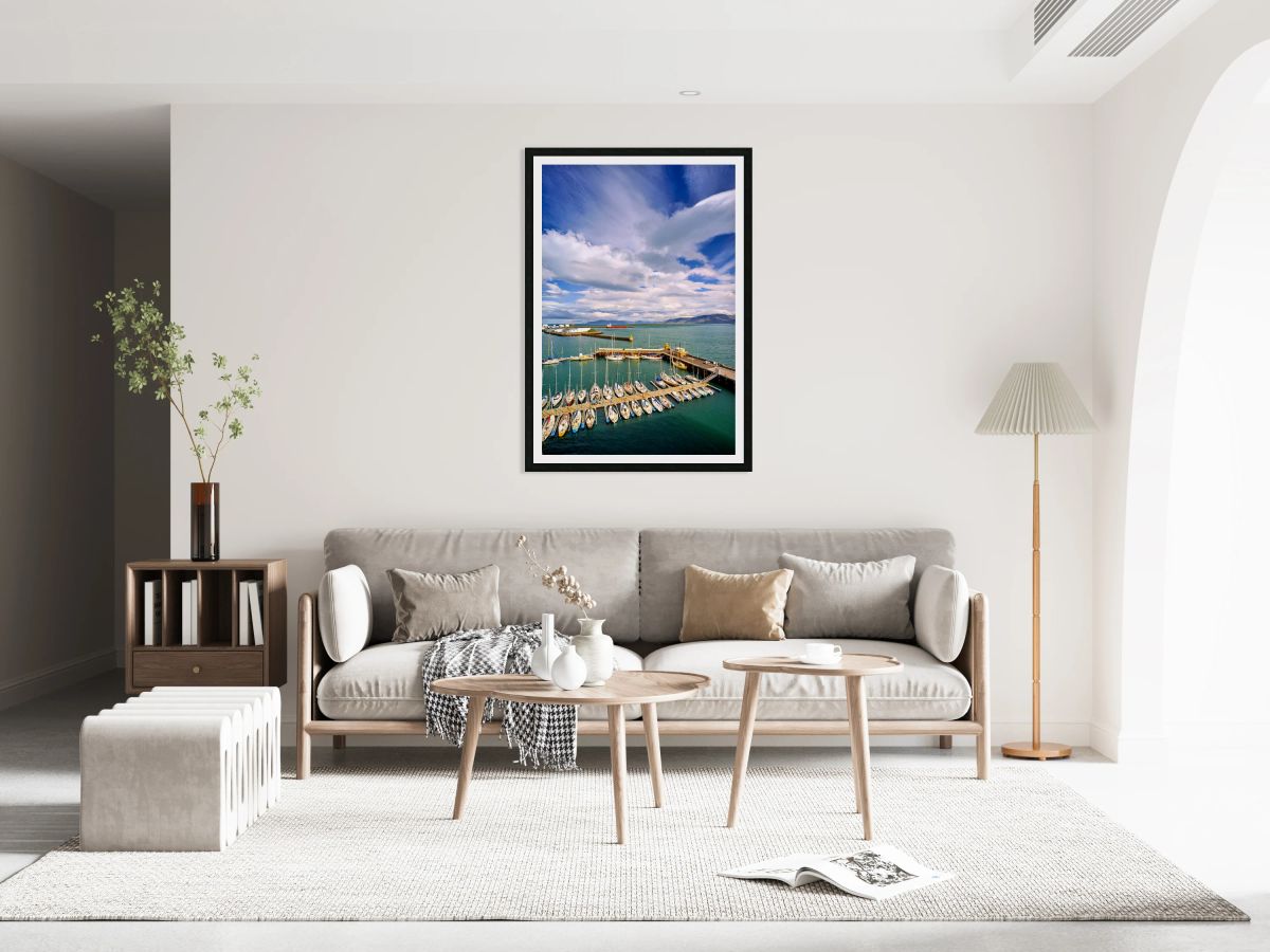 Sailboats docked in Reykjavik harbor under cloudy sky