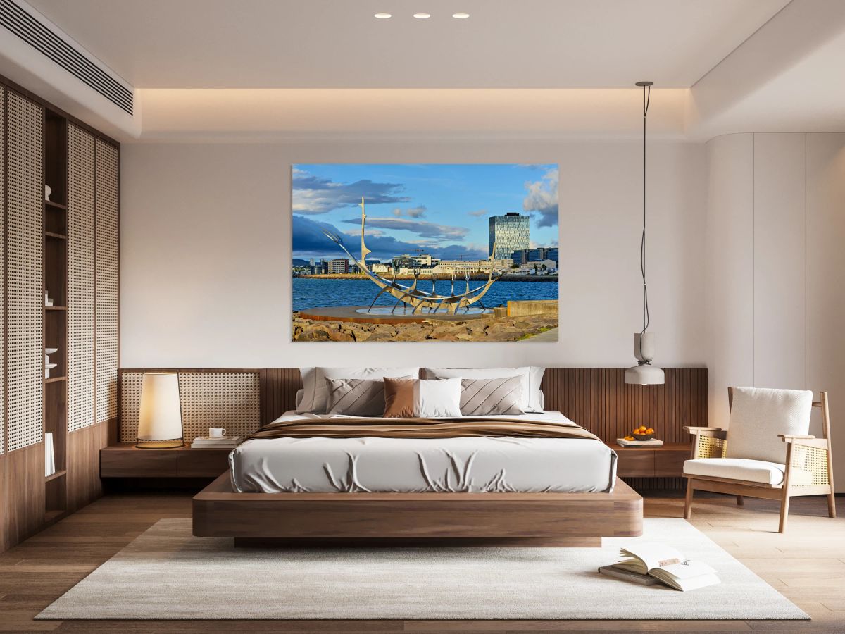 Visitors explore Sun Voyager sculpture in Reykjavik city skyline