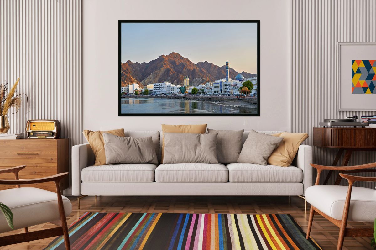 Sunset over Muscat waterfront with mountains behind