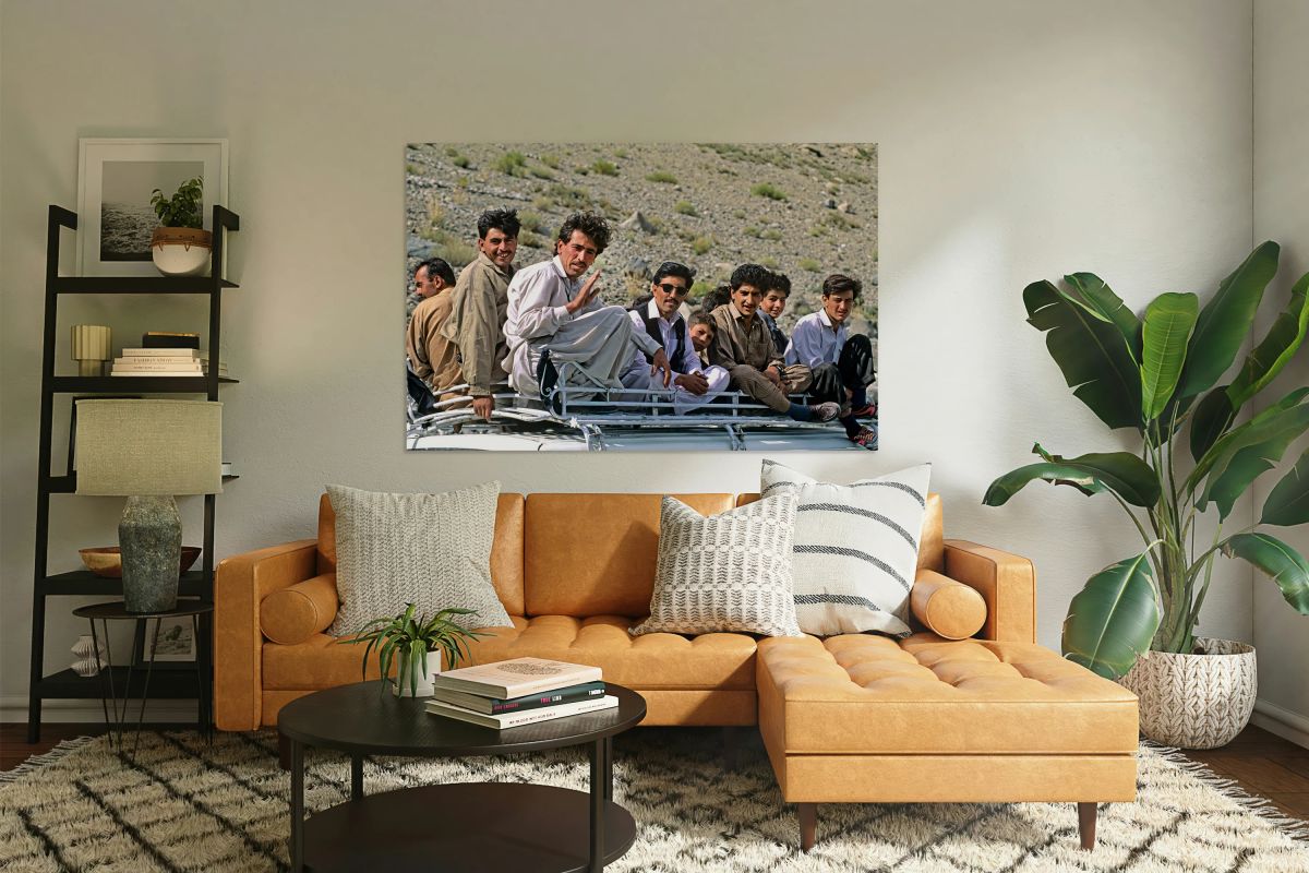 Group traveling on top of a van in Pakistans mountains