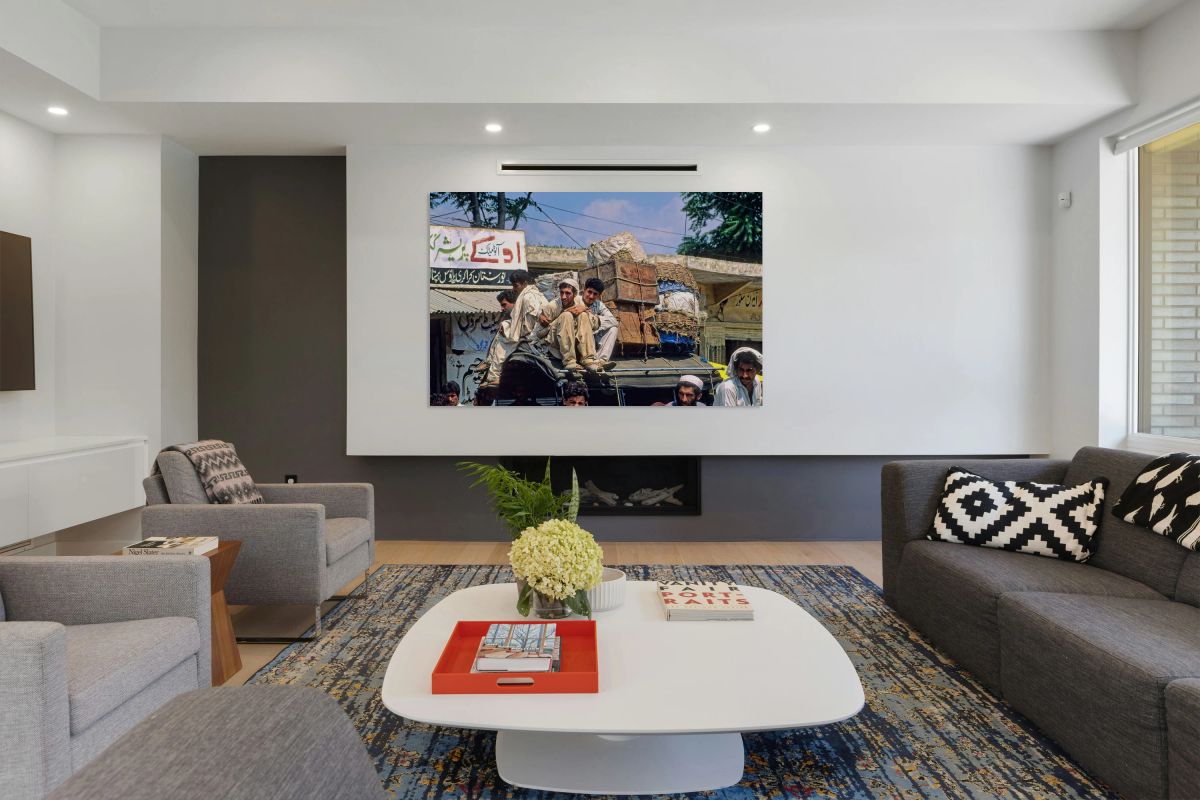 Men travel on top of a vehicle in Peshawar Pakistan