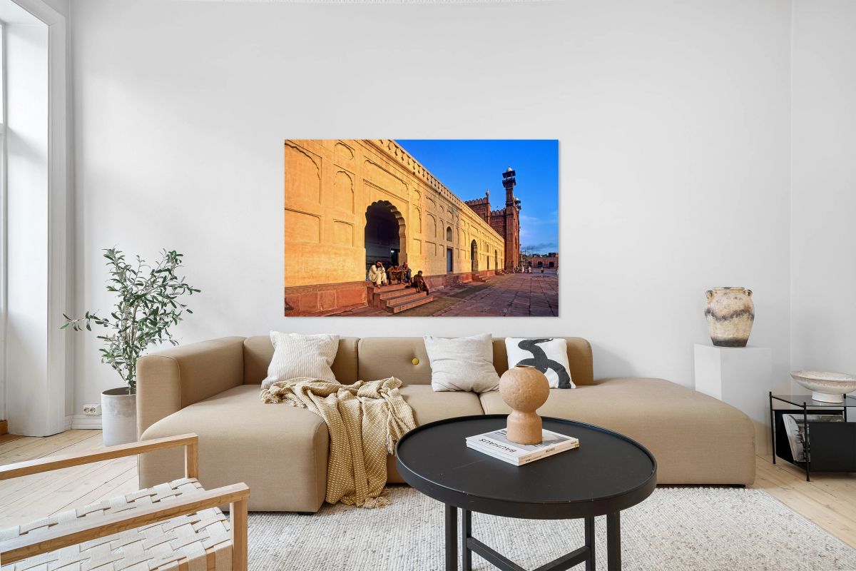 Visitors rest by Badshahi Mosque during sunset in Lahore