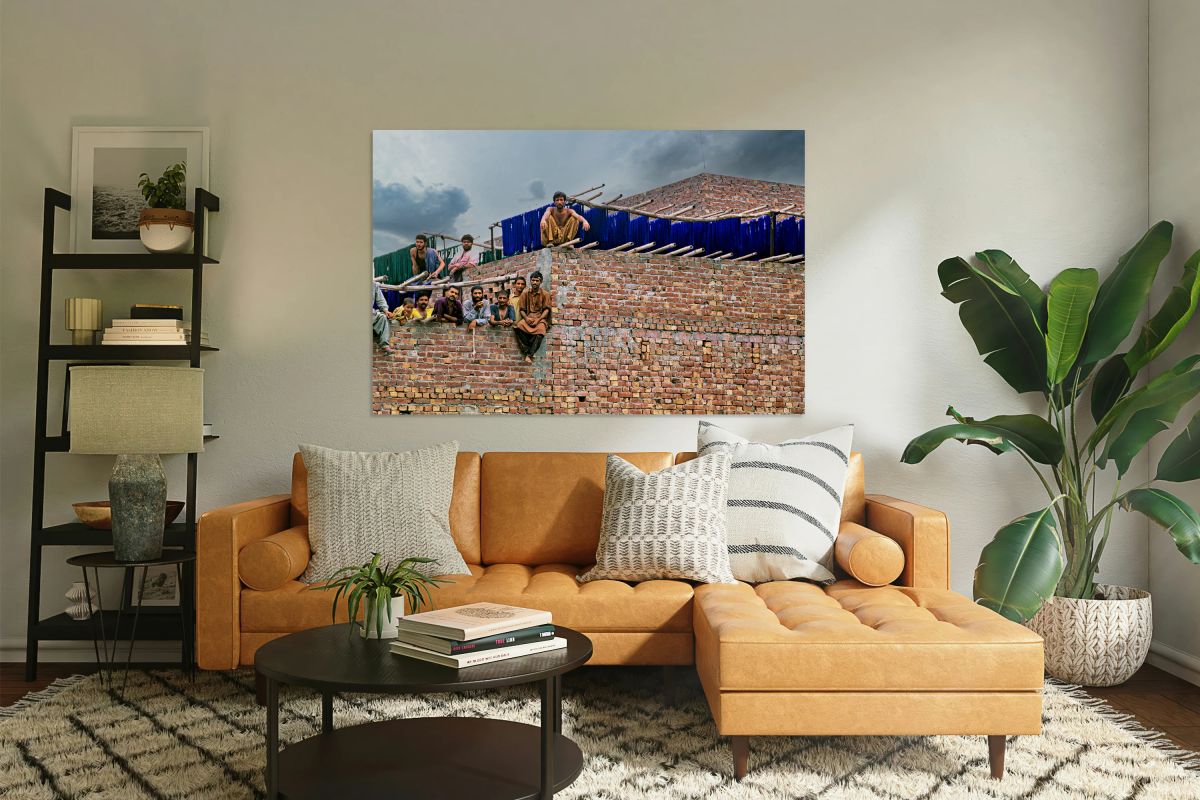 Workers rest during break time at a construction site in Lahore