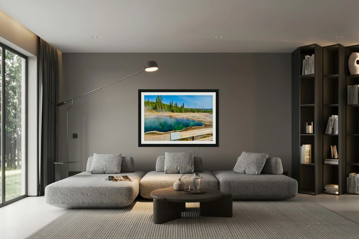 Tourists can see the deep blue Abyss Pool in Yellowstone National Park with steam rising from the hot springs during the warm afternoon.
